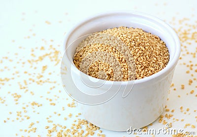 Wholegrain couscous in the bowl on the white background Stock Photo