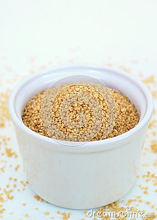 Wholegrain couscous in the bowl on the white background Stock Photo