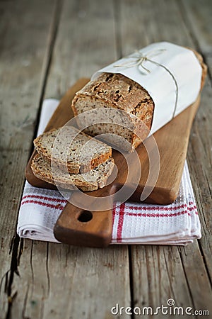 Wholegrain rye bread loaf with flax seeds and oats, sliced Stock Photo