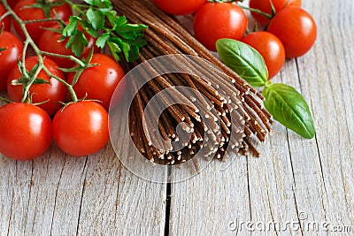 Wholegrain rye spaghetti, tomatoes and herbs Stock Photo