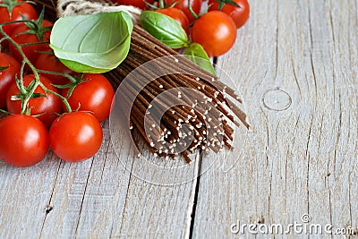 Wholegrain rye spaghetti, tomatoes and herbs Stock Photo