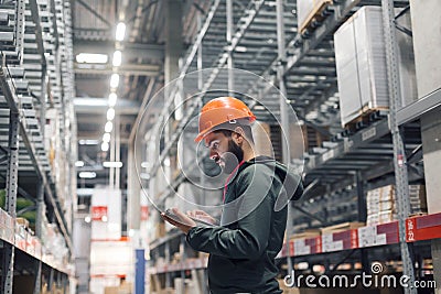 Wholesale, logistic, people and export concept - manager or supervisor with tablet at warehouse Stock Photo