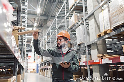 Wholesale, logistic, people and export concept - manager or supervisor with tablet at warehouse Stock Photo