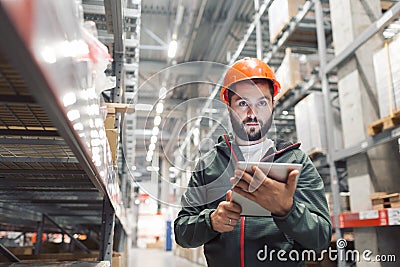 Wholesale, logistic, people and export concept - manager or supervisor with tablet at warehouse Stock Photo