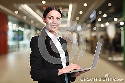 Wholesale and logistics. Manager using laptop in shopping mall Stock Photo