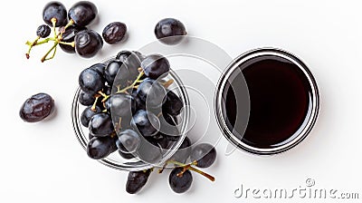 Wholesome Delights: A Captivating Display of Black Grapes and Grape Molasses on a Crisp White Backdr Stock Photo
