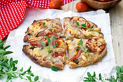 Wholewheat pizza with tomatoes, cheese and herbs Stock Photo