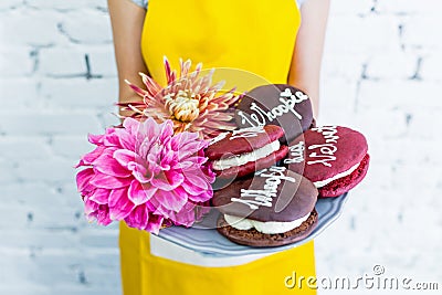 Whoopie pies on a tray with flowers, women`s hands. Congratulations. Stock Photo