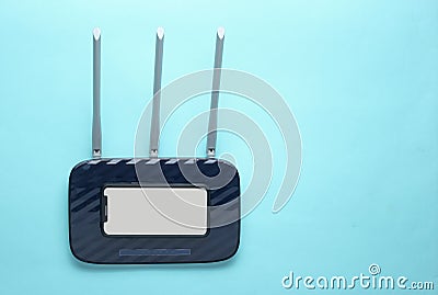 Wi-fi router, smartphone on blue background Stock Photo