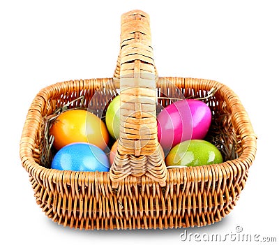 Wicker basket with colorful Easter eggs Stock Photo