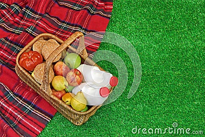 Wicker Basket With Food And Drink On the Picnic Blanket Stock Photo