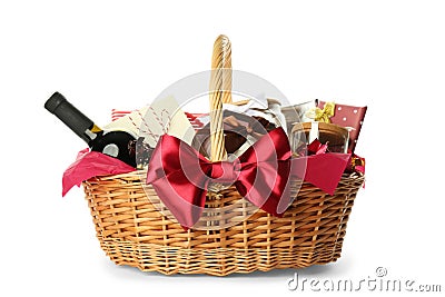Wicker basket full of gifts isolated on white Stock Photo