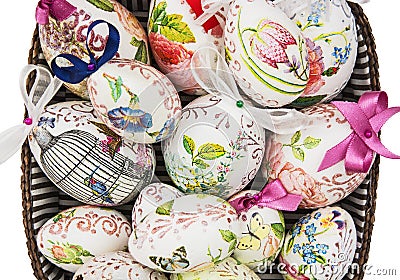 Wicker basket full of painted colorful Easter eggs Stock Photo