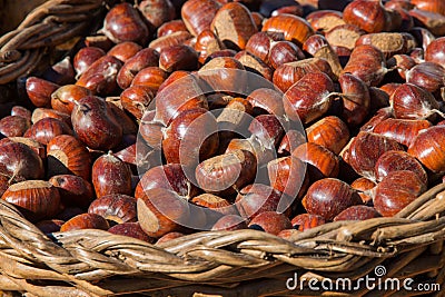 Wicker Basket full of sweet organic Chestnut at country market Stock Photo