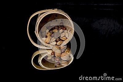 Wicker basket with mixed nuts Stock Photo