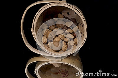 Wicker basket with mixed nuts Stock Photo