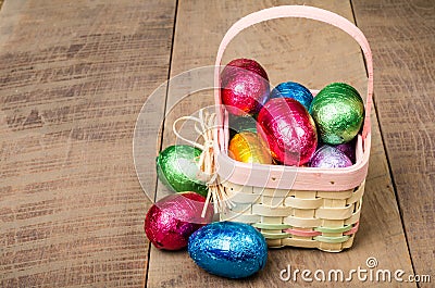 Wicker Easter basket with foil chocolate eggs Stock Photo