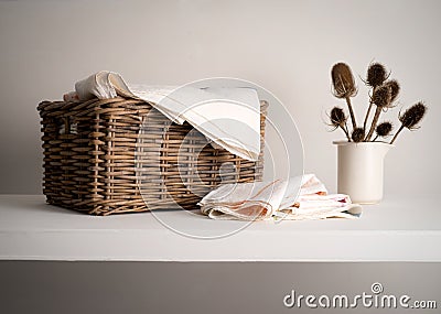 Wicker Linen basket on a shelf Stock Photo