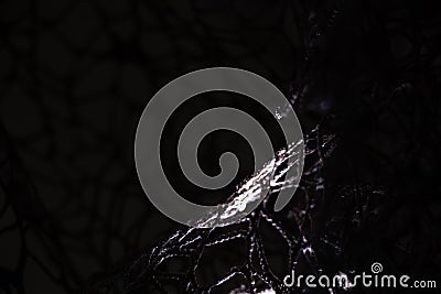 Wicker mesh of threads as a background with a soft blurred focus in the dark as a background ,abstract Stock Photo