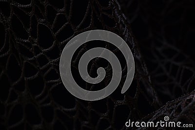 Wicker mesh of threads as a background with a soft blurred focus in the dark as a background ,abstract Stock Photo