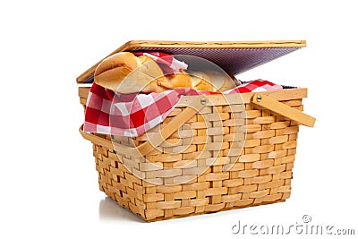 Wicker picnic basket with bread on white Stock Photo