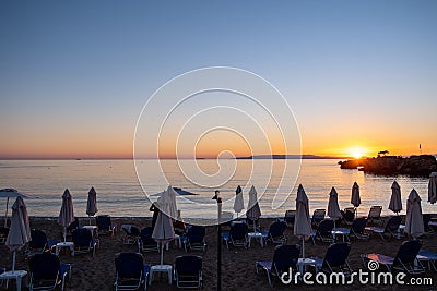 Wicker umbrella silhouette at Stoupa sandy beach at sunset. Mani Messenia, Greece Peloponnese Stock Photo
