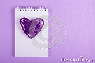 Wicker Valentine and white notes on a purple background. Handmade. Valentine`s Day. Stock Photo