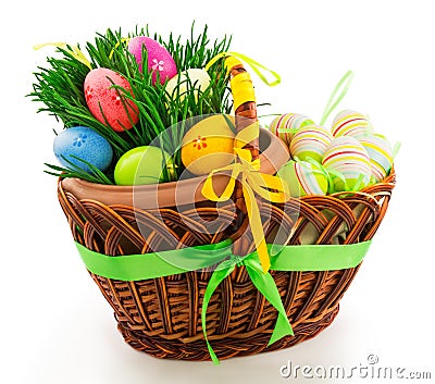 Wicker wooden basket with Easter eggs and fresh grass Stock Photo