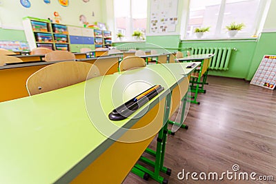 Wide angle desks and chairs in classroom. Stock Photo