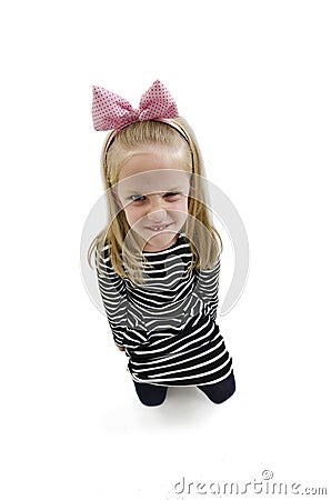 Wide angle photo of a little girl shows her furrowed brow and irritated frown Stock Photo