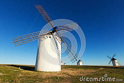 Wide angle shot of group of windmills in sunny day Stock Photo