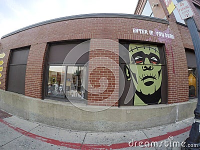 Wide angle view building with scary face mural Editorial Stock Photo