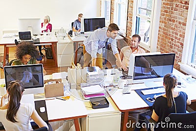 Wide Angle View Of Busy Design Office With Workers At Desks Stock Photo