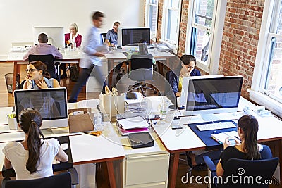 Wide Angle View Of Busy Design Office With Workers At Desks Stock Photo