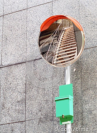 Wide angle view convex mirror installed inside staircase on bridge across river Stock Photo
