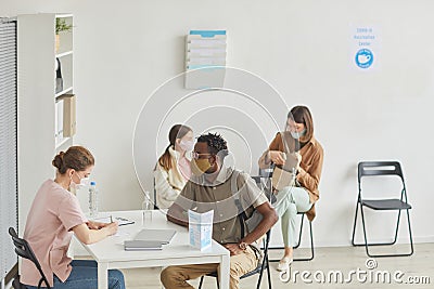 African American Man Registering at Vaccination Center Stock Photo