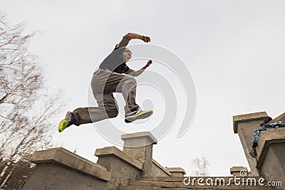 Wide angle view - parkour jumping in winter snow park - free-run training Stock Photo