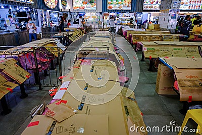 Wide angle view of a typical local food centre. No dining-ins allowed during covid-19. Tables and seats are covered up Editorial Stock Photo