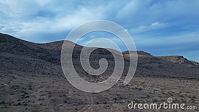 Wide arid valley with a mountain range. Stock Photo