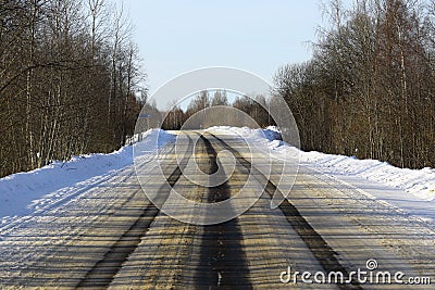 Wide asphalt road, on which there are ruts from cars on the roadway Stock Photo