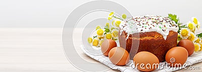 Wide banner with Easter cake and colored eggs yellow flower blossoms on background. Holiday food and easter concept. Copyspase for Stock Photo