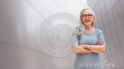 Wide banner panorama portrait of elder, senior, older CEO business woman standing confident, smiling, with arms folded, copy space Stock Photo