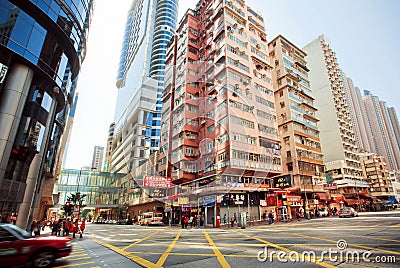 Wide broad street with skyscrapers and fast driving taxi car on city road of Hong Kong Editorial Stock Photo