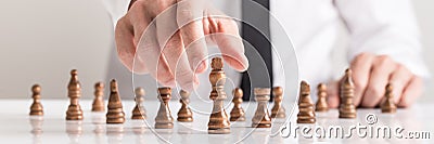 Wide cropped image of a businessman in white shirt playing chess Stock Photo