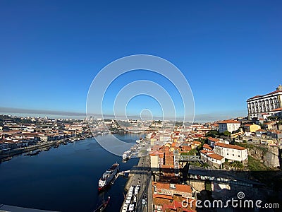 Wide Douro river with some boats sailing in a beautiful skyline from the city Porto, in Portugal Editorial Stock Photo