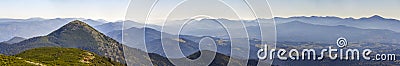 Wide panorama of green mountain hills in sunny clear weather. Carpathian mountains landscape in summer. View of rocky peaks covere Stock Photo