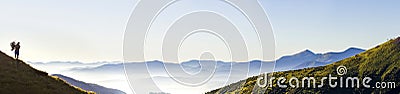 Wide panorama of morning mountain hills and lonely hiker tourist Stock Photo