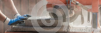 Wide panorama view of a building contractor using an angle grind Stock Photo