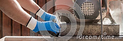 Wide panorama view of a building contractor using a circular saw Stock Photo
