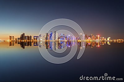 Wide panoramic view to the illuminated skyline of Doha in Qatar Editorial Stock Photo